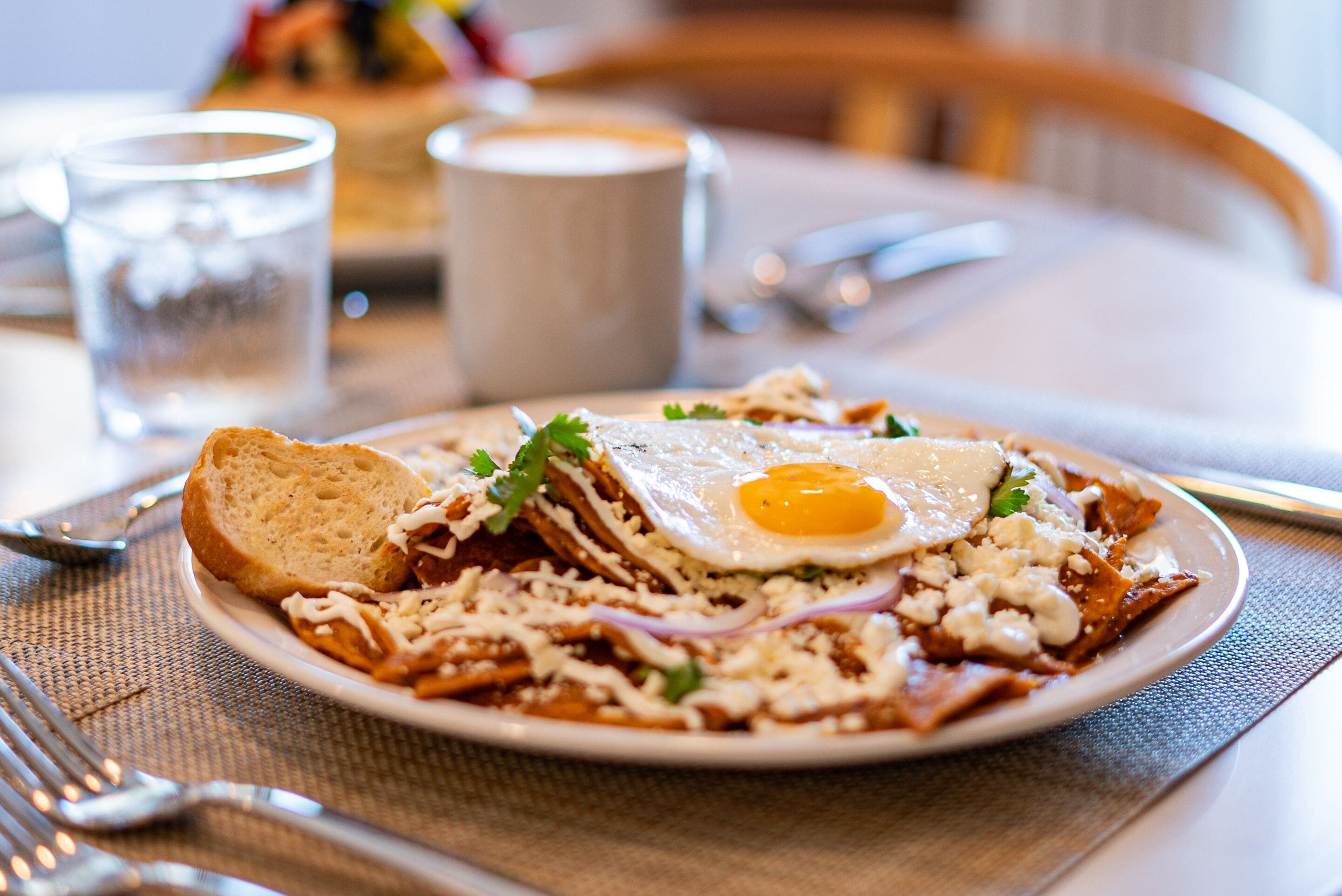 A plate of food with a fried egg, bread, and various toppings.