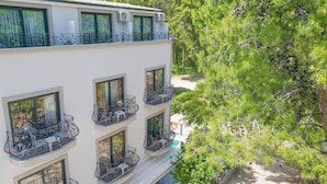 A multi-story hotel with balconies, each with metal railings and outdoor seating. - Ada Butik Hotel (Marmaris)