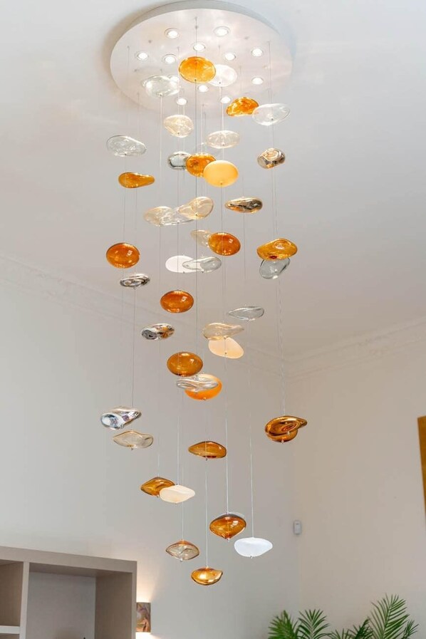 A ceiling with a series of hanging, translucent, oval-shaped objects.