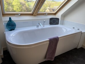 Bathtub, hair dryer, towels, soap