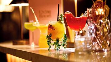 A bar area with various drinks and a decorative glass sculpture.