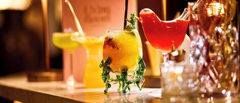 A bar area with various drinks and a decorative glass sculpture.
