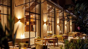 An indoor dining area with wooden furniture and warm lighting. - Park Hyatt Marrakech (Marrakech)
