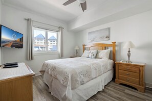 A bedroom with a bed, nightstands, a desk, a TV, and a window with curtains. - Popular Adagio building, mid-town on the ocean! (Ocean City)