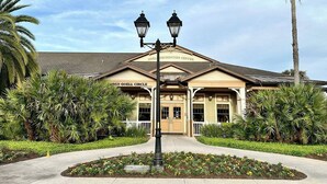 A building with a sign reading "Odell Recreation Center" and "Odell Circle" with a landscaped entrance and palm trees. - Sun Splashed - 3/2 w/ Golf Cart in The Village of Amelia (The Villages)