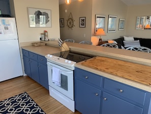 Enjoy cooking in this well-equipped kitchen with a central island, stove, and oven.