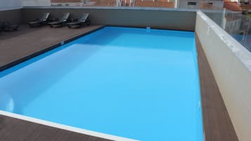 Seasonal outdoor pool, open 10:00 AM to 7:00 PM, pool loungers