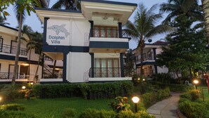 A two-story building with a sign reading "Dolphin Villa."