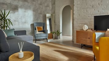 Deluxe Apartment | Living area | 106-cm flat-screen TV with cable channels, TV