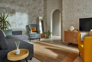 Apartamento Deluxe | Zona de estar | Televisión de pantalla plana de 106 cm con canales por cable