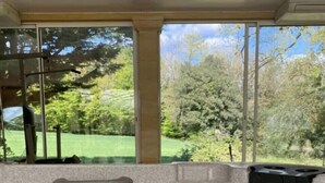 A hot tub area with a view of a green landscape through large windows. - Villa & Spa Heated pool Périgord 5 min from Sarlat (Sarlat-la-Canéda)