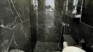 A bathroom with a marble floor, a toilet, a sink, and a shower area. - House with spa surrounded by nature in Saint Paul de Vence (Saint-Paul-de-Vence)