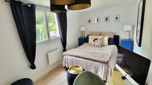 A bedroom with a bed, bedside tables, a chair, a desk, and a window with curtains. - House with spa surrounded by nature in Saint Paul de Vence (Saint-Paul-de-Vence)