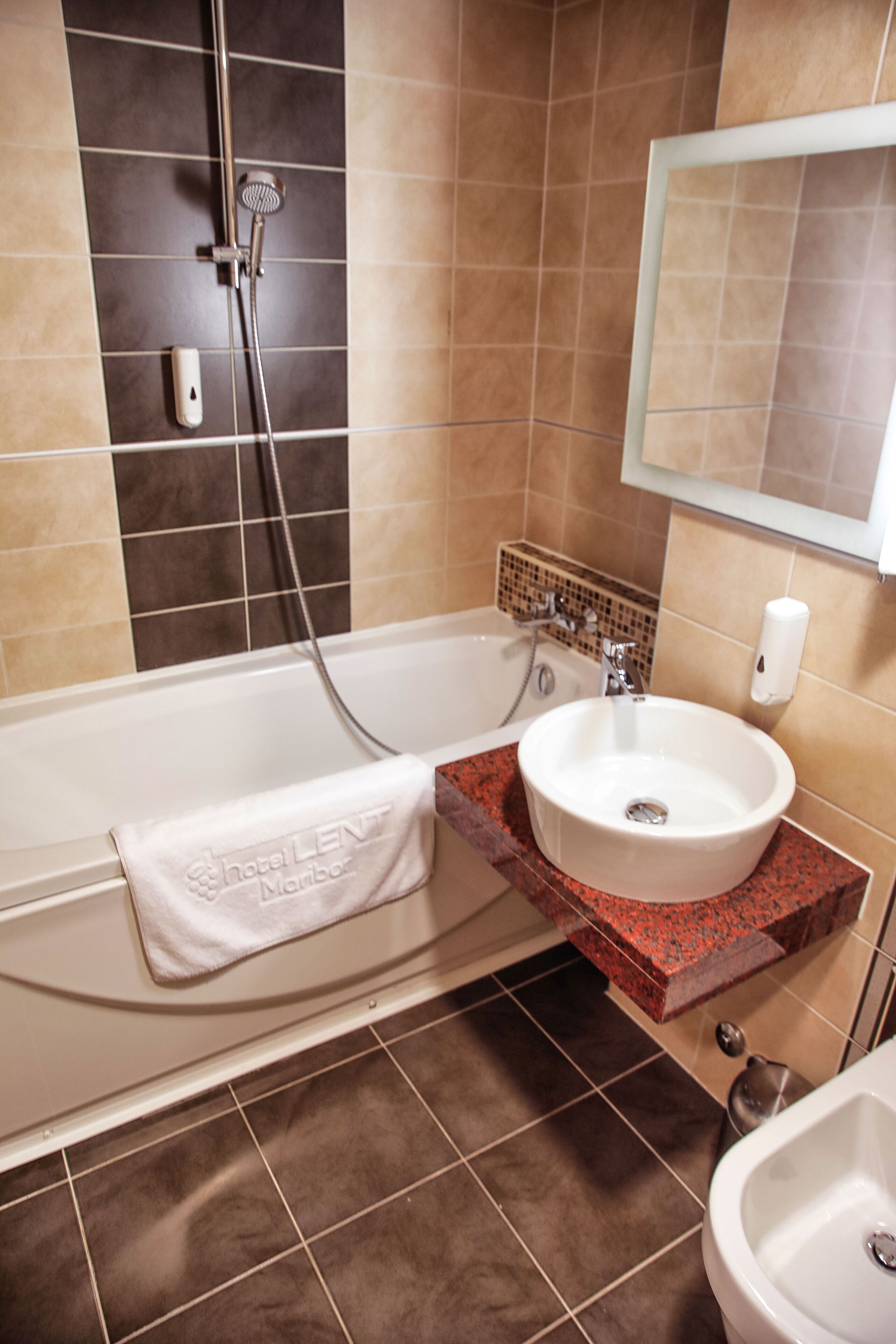 A bathroom with a bathtub, a sink, and a shower.