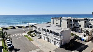 A multi-story building with balconies overlooking a beach. - Ocean View From Private Patio | Across From Beach (Carlsbad)