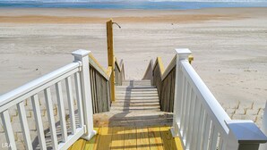 A wooden staircase leading to a beach with a railing on both sides. - Beach House - Pet-Friendly Oceanfront Gem (Surf City)