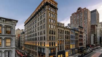 A multi-story building with a classic architectural style, featuring a corner entrance and multiple windows.