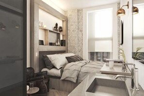 A modern bedroom with a bed, bedside table, and a built-in shelf with decorative items. - Walker Hotel Tribeca (New York)