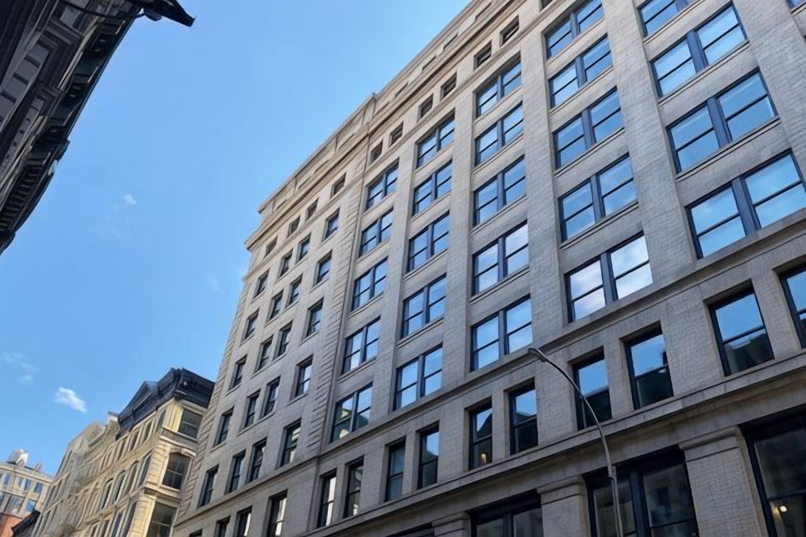 A multi-story building with a grid of windows and a flat facade.