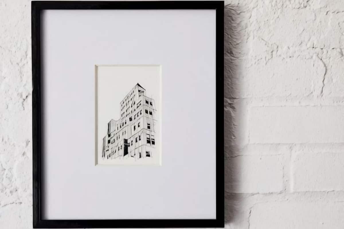 A framed black and white architectural drawing of a building.