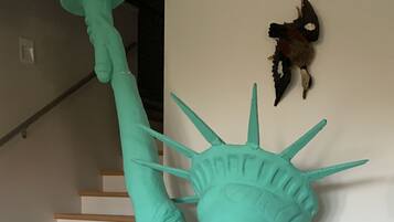 A turquoise statue of the Statue of Liberty in a stairwell.