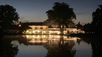 A building with arched windows and a reflection in the water.