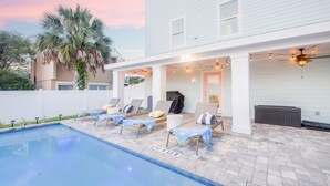 A poolside area with lounge chairs, a covered seating area, and a barbecue grill. - Heated Pool | Game Room | Elevator | Tiki Hut (St. Augustine)