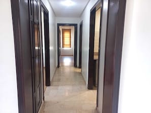 Corridors lead to rooms with windows and doors.