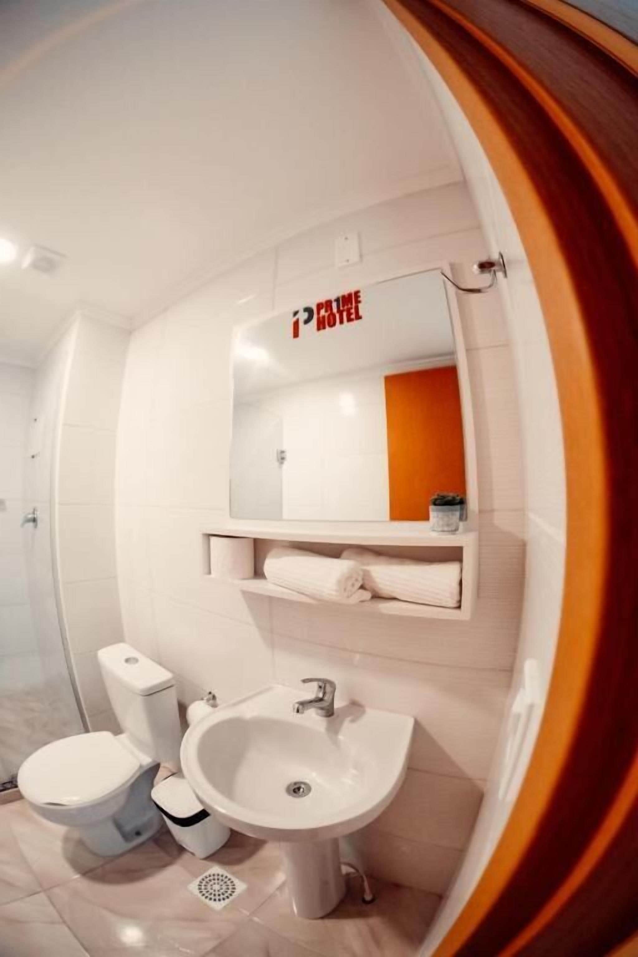 A modern bathroom with a toilet, bidet, and sink.