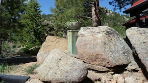 A rock garden with large boulders and a potted plant.