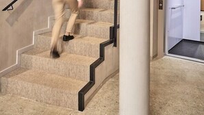 A modern interior with a staircase, a large column, and a door leading to another room. - Joe´s Gomila Boutique Hotel (Palma)