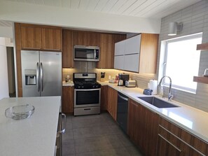 Enjoy cooking in this well-equipped kitchen with a refrigerator, microwave, oven, and dishwasher.