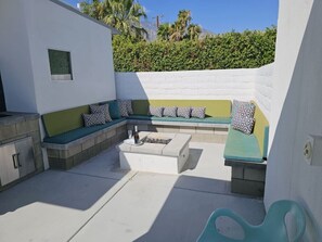 Relax in an outdoor space with a seating area and fire pit.