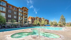 A hotel with a pool area, including a hot tub and lounge chairs. - Larkspur Luxe - Northstar- 4 BR w Pool, Gym, Access - Walk to Village. Hot Tub! (Truckee)