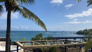 A beach view with a wooden deck, lounge chairs, and a hot tub. - Just right (Puerto Plata)