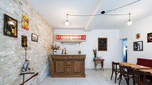 A restaurant with a stone wall, wooden counter, and a sign reading "STELLA ARTOIS".