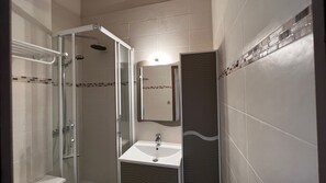 Shower, hair dryer, soap, toilet paper