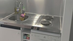 A compact kitchen with a microwave, coffee maker, sink, and dishwasher. - Cosy T2 sea view, bedroom + cabin, mezzanine, parking (Fleury)