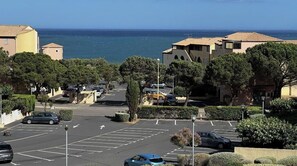 Enjoy stunning sea views from this coastal retreat surrounded by lush greenery and picturesque buildings with terracotta roofs.