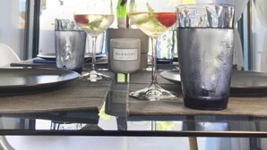 A table with a potted plant, a bottle of Harmony water, and two glasses of water. - Minimal Resort & Pool in Siviri, 150m From the Sea (Kassandra)
