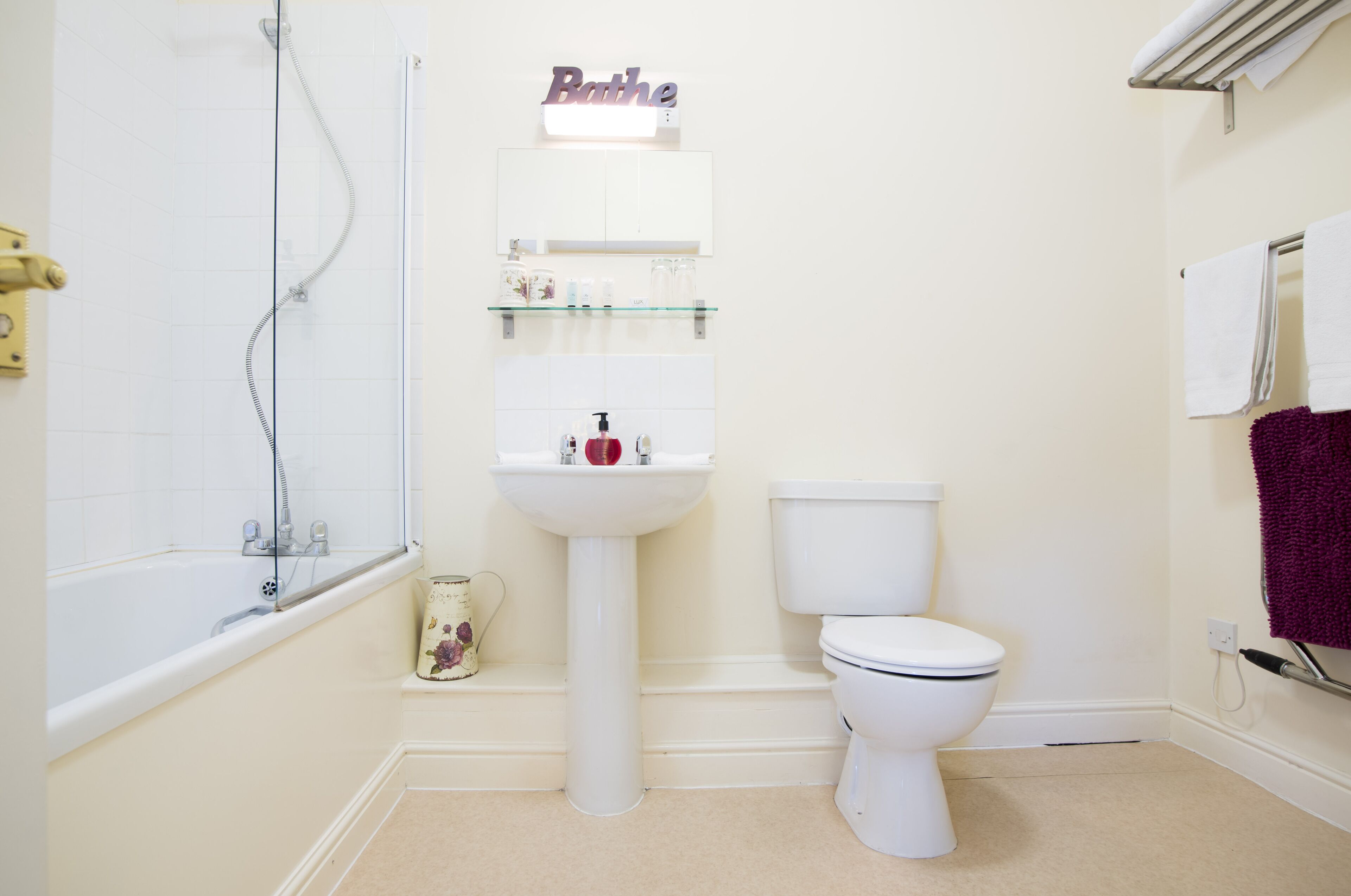 A bathroom with a bathtub, a sink, a toilet, and a shower.