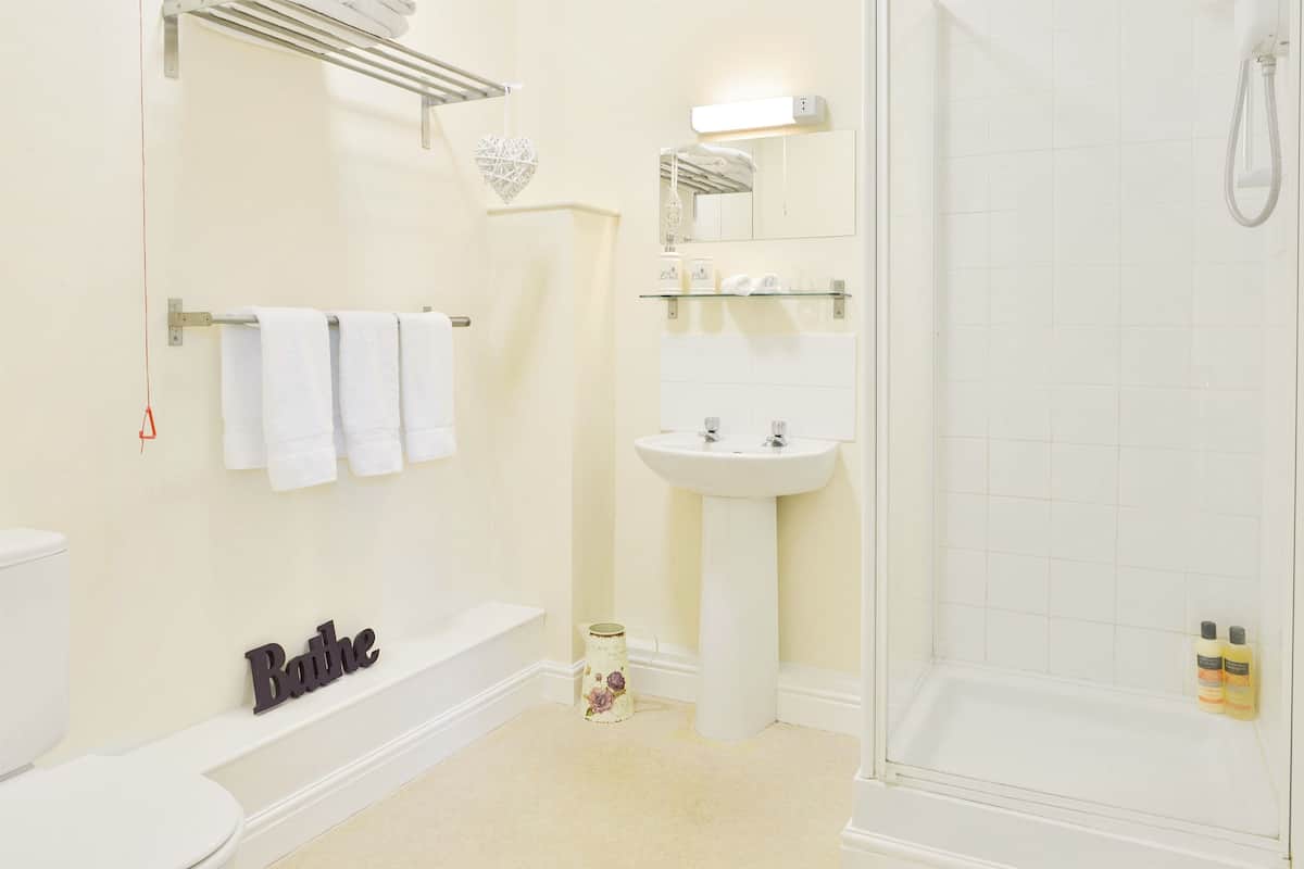 A bathroom with a toilet, a bathtub, a sink, and a shower.
