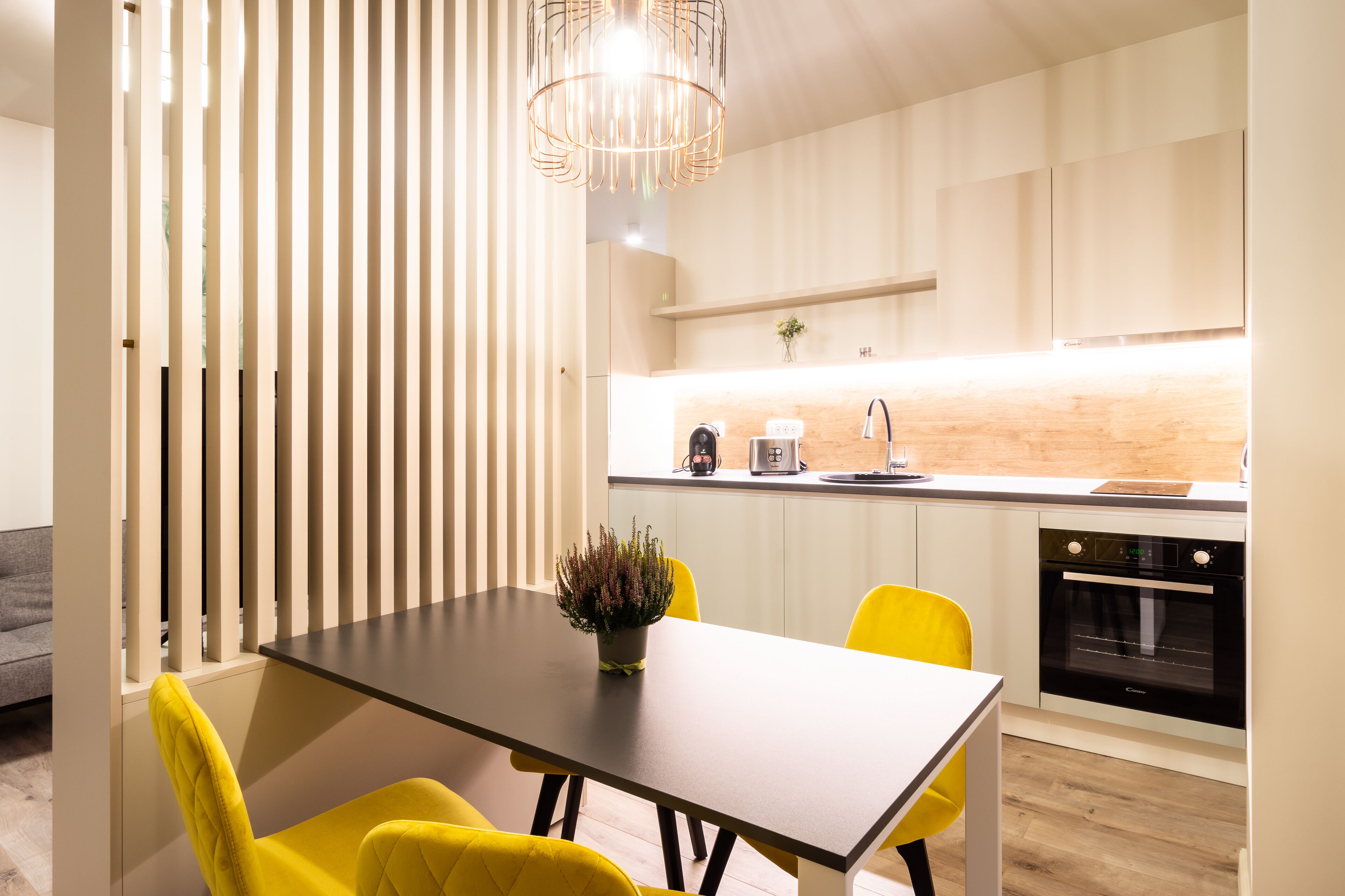 A modern kitchen with a dining area.