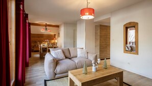A modern living room with a sofa, a wooden coffee table, and decorative Christmas trees. - Duplex 4 rooms, 8 max, pets allowed, balcony (Valloire)