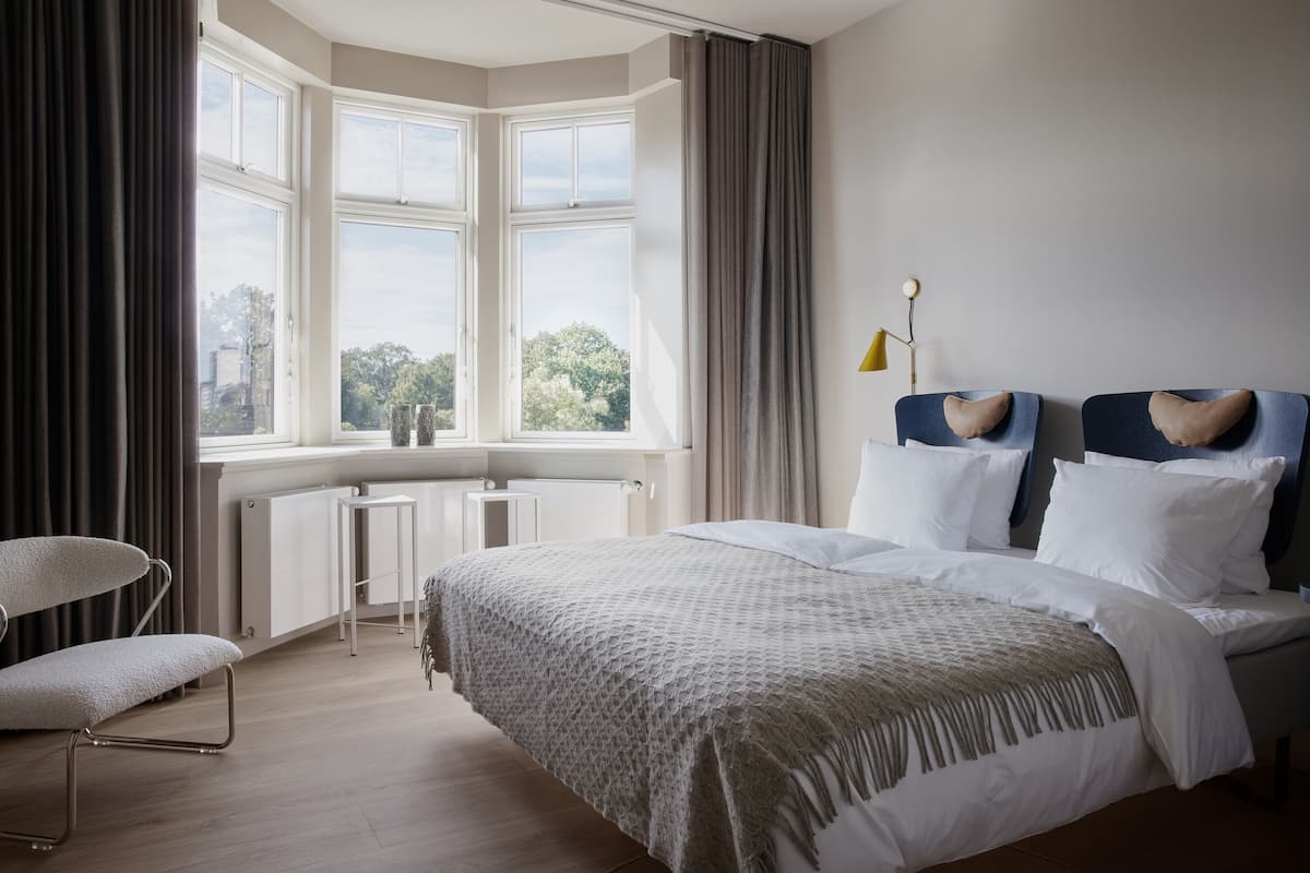 Un dormitorio moderno con una cama grande, un escritorio y una silla.