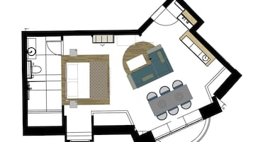 Plano de un cuarto de hotel que muestra una cama, un baño pequeño, una kitchenette y una zona de estar con mesa y sillas.