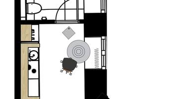 A floor plan with a kitchen, dining area, and a living room with a fireplace.