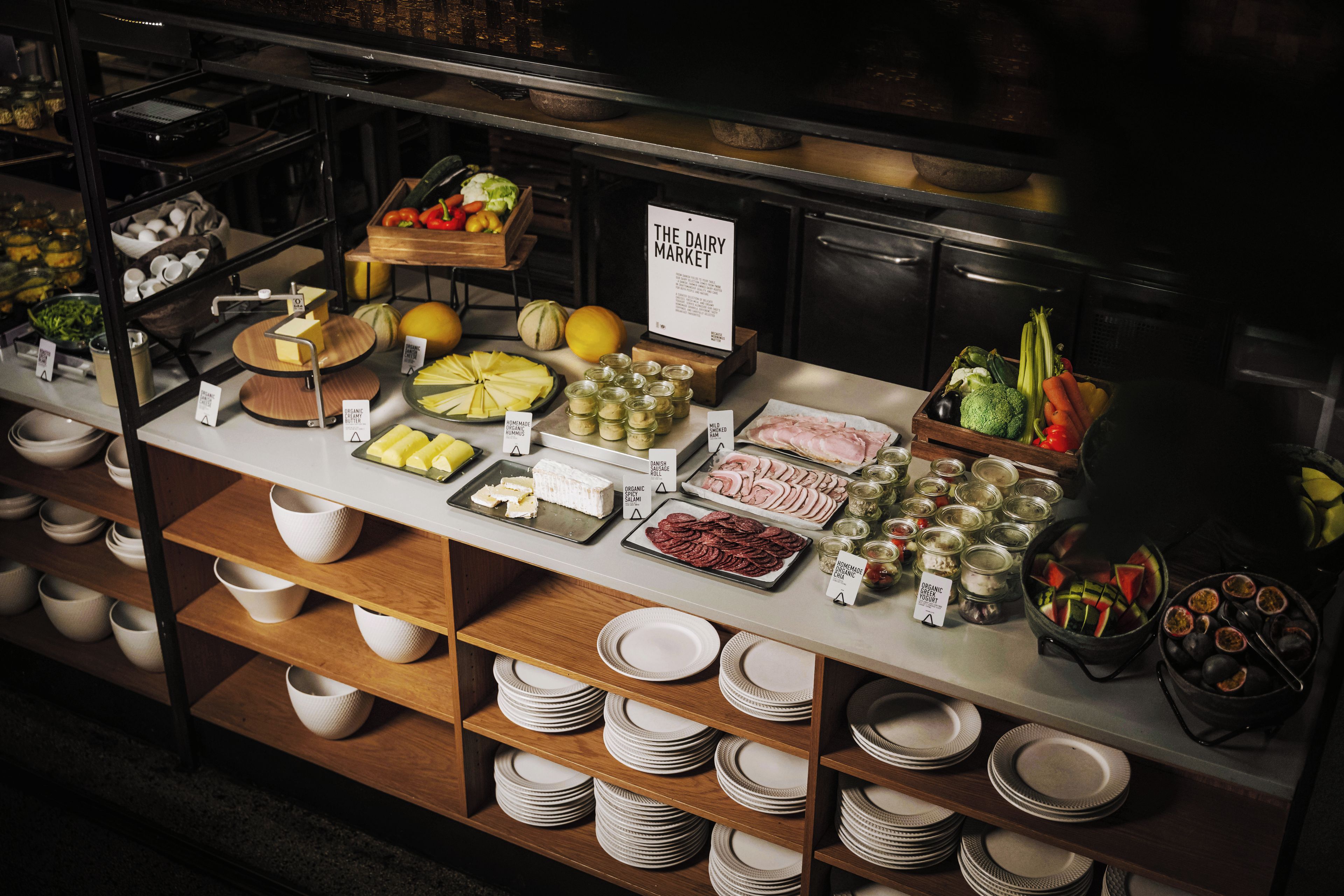 A buffet with various food items and condiments.