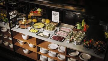 A buffet with various food items and condiments.