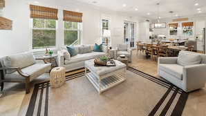 A spacious living room with a sofa, armchairs, and a dining area with a table and chairs. - All Decked Out (Santa Rosa Beach)